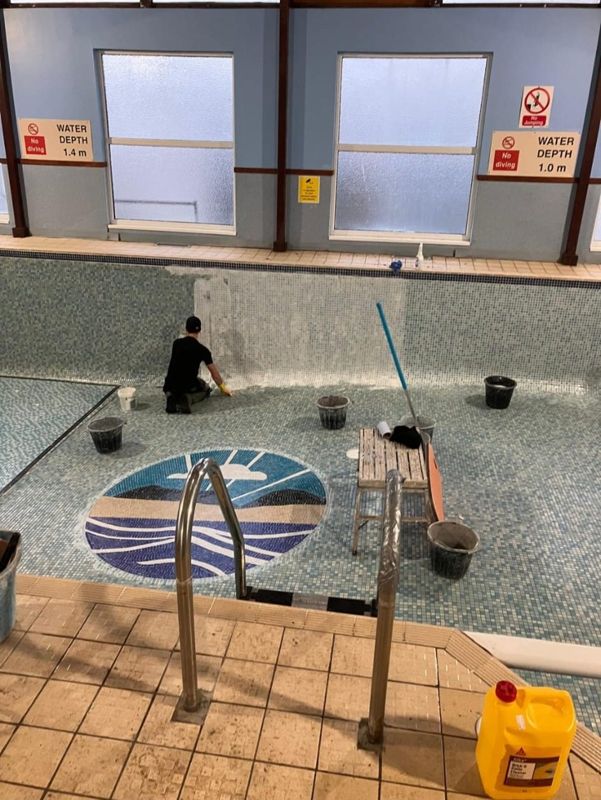 Work on a mosaic pool floor
